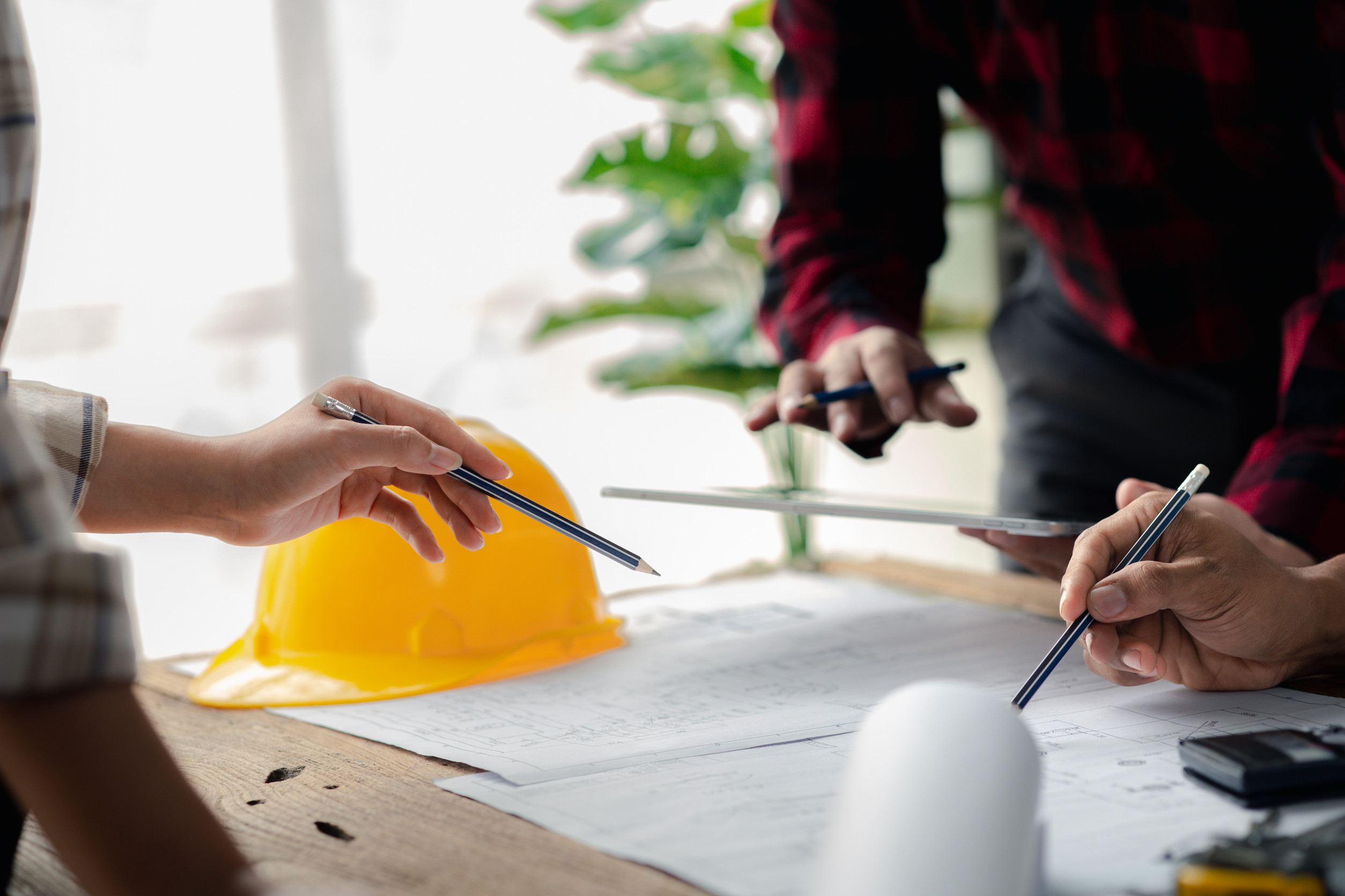 The home design architects are reviewing the house plan draft, the project commissioned by the client, and the custom design before delivery. Interior design and decoration ideas.<br />